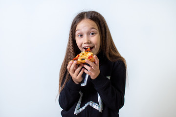 Little brunette girl eating pizza