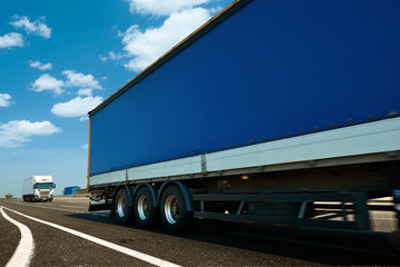 Naklejka na ściany i meble Commercial delivery cargo truck on highway traffic