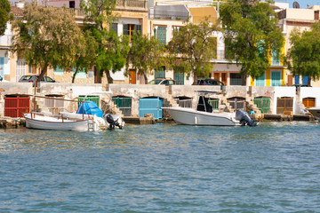 Fototapeta na wymiar Colorful garages for boats in the harbor at Portocolom. Mallorca, Spain