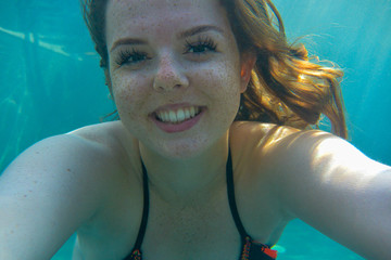 Young woman taking selfie underwater
