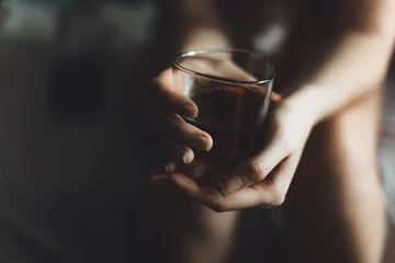  woman's hand with alcohol drink in glass with copy space © Danil Nikonov
