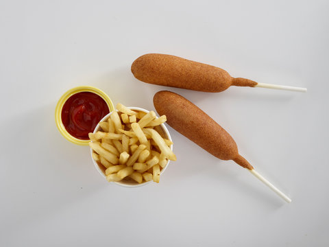 Corndogs with french fries and ketchup