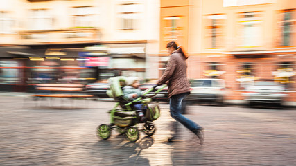 Mother with small children and a pram