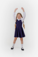 School girl posing for a picture cheerfully on white background