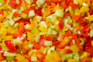 Background of finely chopped peppers.A salad of multi-colored peppers, yellow, red.Photo.