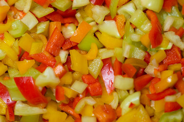 Background of finely chopped peppers.A salad of multi-colored peppers, yellow, red.Photo.