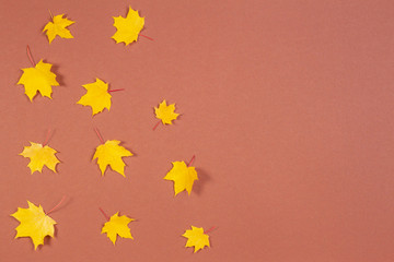 Autumn composition. Frame made of autumn maple leaves on brown background