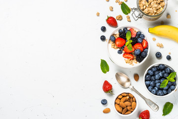 Greek yogurt granola with fresh berries on white table.