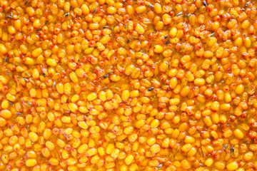 Fresh sea buckthorn jam. Close-up. Top view. Background. Texture.