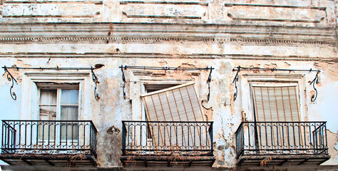 Fototapeta na wymiar Three windows white with balconies in ruins