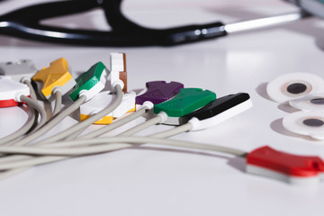 Closeup electrodes of electrocardiograph with stethoscope, heart care concept	