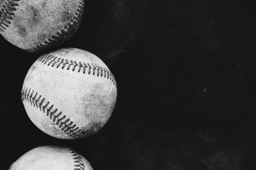 Baseball balls background for sports concept in black and white, closeup of old used ball player equipment with copy space.
