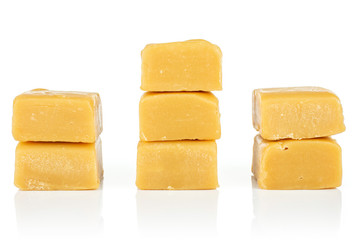 Group of seven whole sweet golden caramel candy isolated on white background