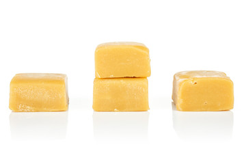 Group of four whole sweet golden caramel candy isolated on white background