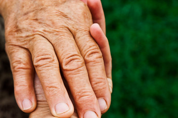 Close-up of hands of daughter and old mother