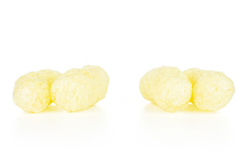 Group of four whole salted yellow corn puff isolated on white background