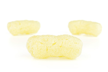Group of three whole salted yellow corn puff isolated on white background