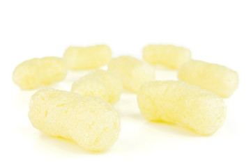 Group of eight whole salted yellow corn puff isolated on white background