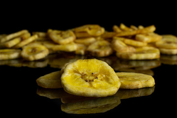 Lot of slices of sweet yellow dry banana three are in the front and the rest is in the back...