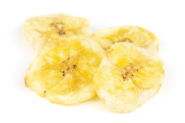Group of four slices of sweet yellow dry banana isolated on white background