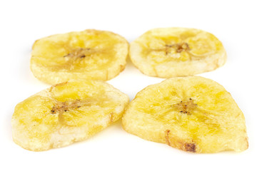 Group of four slices of sweet yellow dry banana isolated on white background