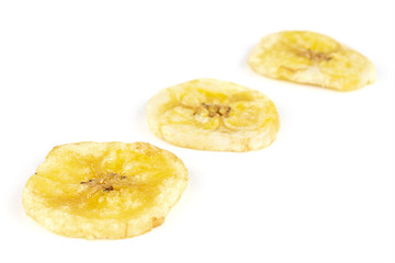 Group of three slices of sweet yellow dry banana isolated on white background