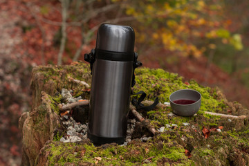 Thermos with a cup of tea
