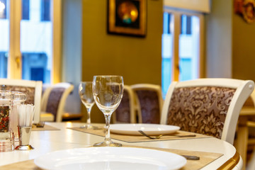 Laid table in the restaurant waiting for guests.