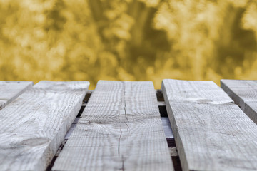 Wooden table and blurred Autumn background