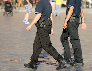 policeman in uniform and guns patrolling the city