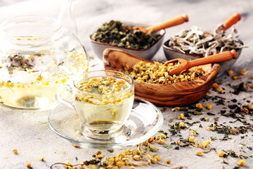 Fototapeta na wymiar tea with Chamomile, sage and stinging nettle tea. Dried chamomile tea on table