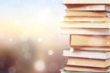 Stack of colorful books on blurred background
