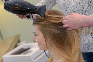 Fototapeta premium a hairdresser styling customers hair