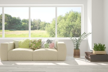 Stylish room in white color with sofa and summer landscape in window. Scandinavian interior design. 3D illustration