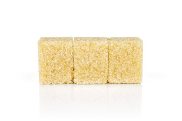 Group of three whole sweet brown sugar cube isolated on white background