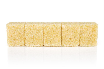 Group of five whole sweet brown sugar cube isolated on white background