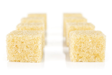 Group of eight whole sweet brown sugar cube isolated on white background