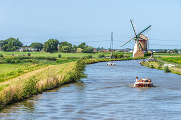 Fototapeta premium Leisure boats in dike canal in the Netherlands