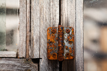 Old door hinge. Beautiful metal door hinge. Antique rusty door hinge, hardware element.