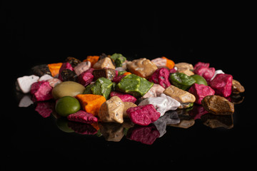 Lot of whole sweet chocolate stone isolated on black glass