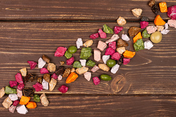 Lot of whole sweet chocolate stone flatlay on brown wood
