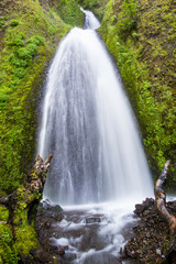 Waterfall flowing down moss covered cliffs - Wahkeena Falls in Oregon's Columbia River Gorge