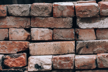 Old bricks. A pile of old bricks. Brickwork photo background. Vintage bricks from an old house.