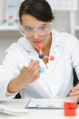 scientist looking at model of a dna chain