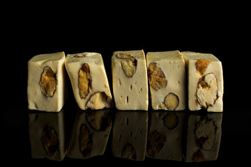 Group of five whole sweet white nougat isolated on black glass