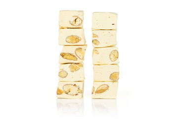 Lot of whole sweet white nougat in two columns isolated on white background