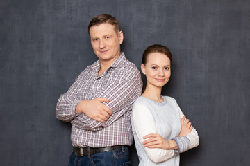 Portrait of happy couple standing back to back and smiling