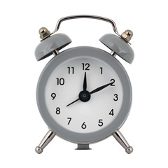 A gray clock with an alarm clock on a white background with arrows showing the time twelve hours ten minutes or twenty four hours ten minutes