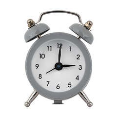 A gray clock with an alarm clock on a white background with arrows showing the time three hours or fifteen hours