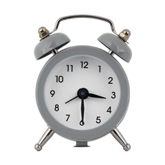 A gray clock with an alarm clock on a white background with arrows showing the time three hours thirty minutes or fifteen hours thirty minutes